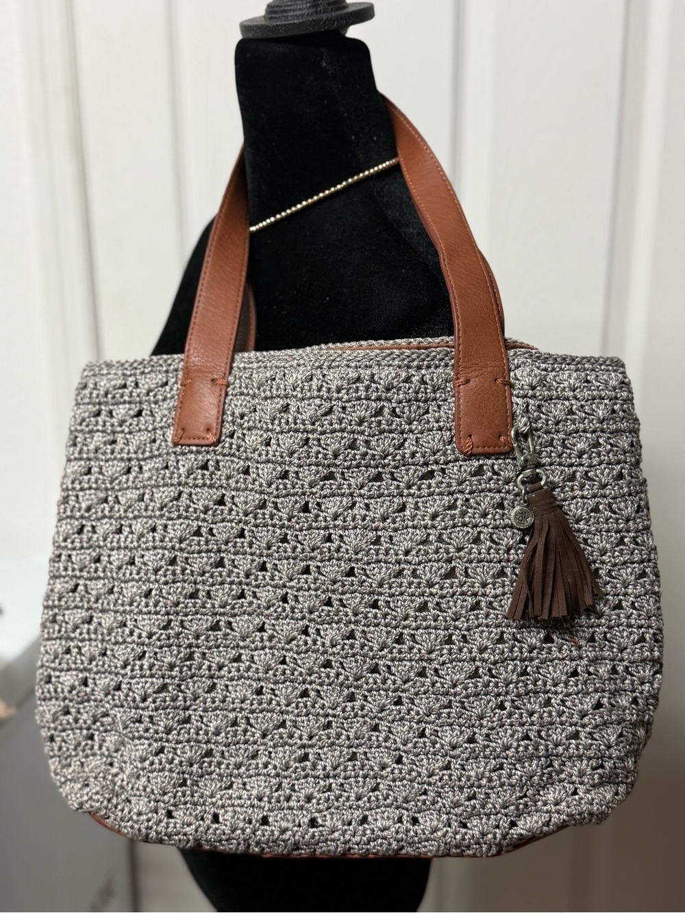 The Sak gray woven tote with brown leather straps